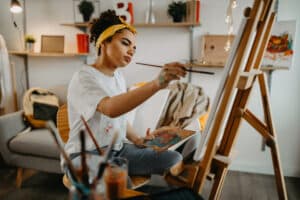 Photo of young females artist in her apartment